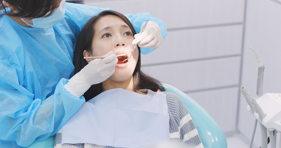Woman undergo check up of tooth in dental clinic Woman undergo check up of tooth in dental clinic